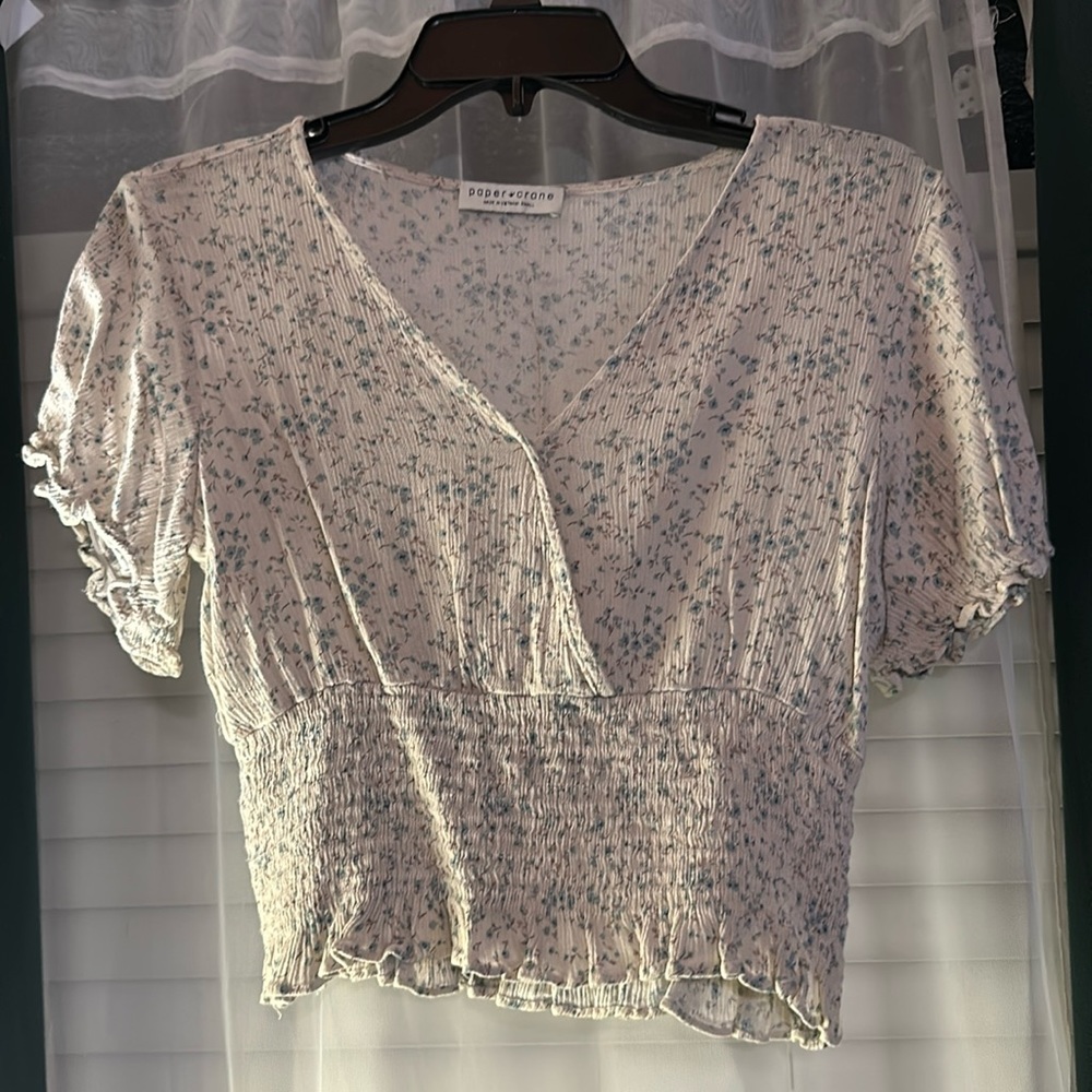 Small cream colored crop top with flowers.